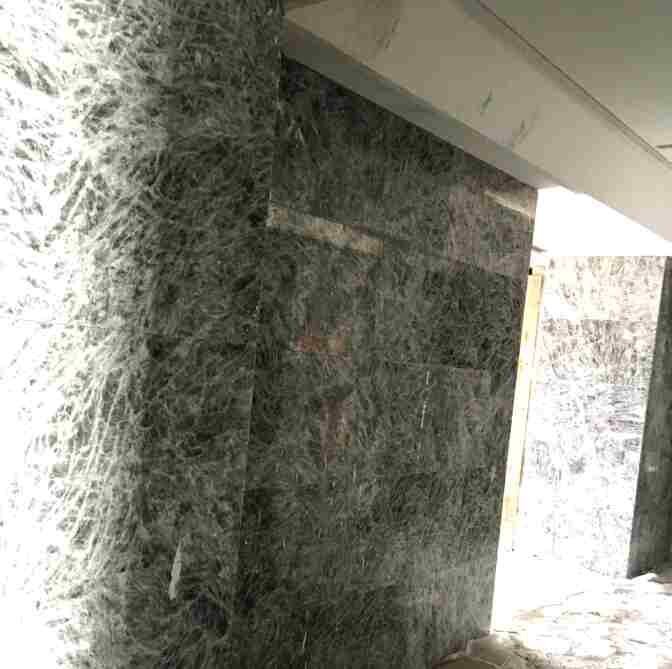 Marble wall cladding, panels matched for vein direction.