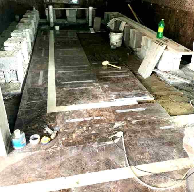 Marble floor being laid to a bordered setting-out.