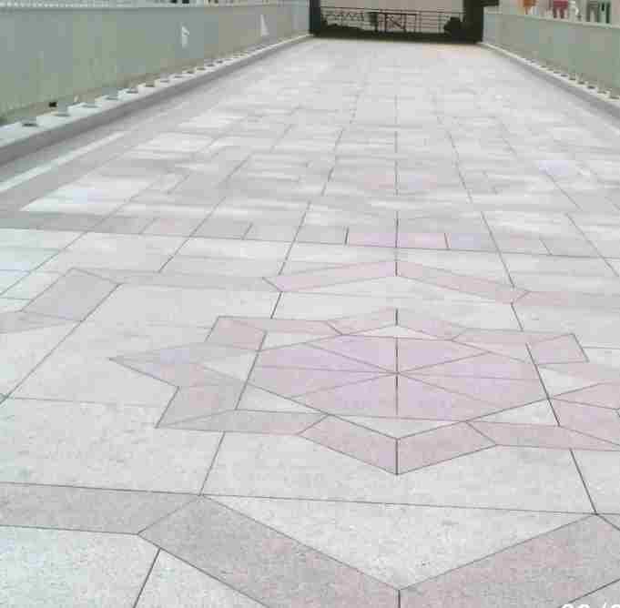 Patterned stone paving set out to a geometric star motif.