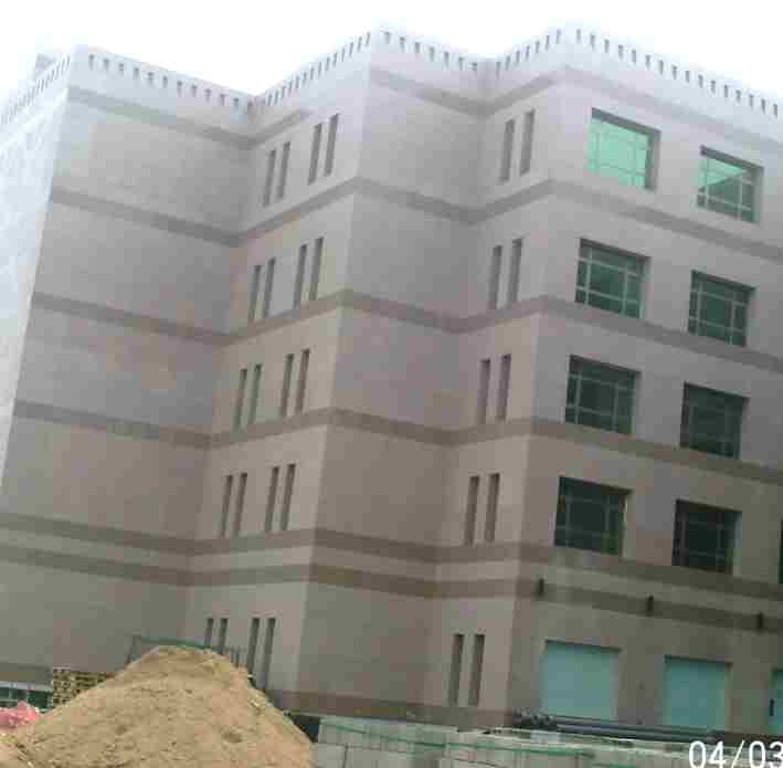 Completed facade with precast banding and window surrounds.