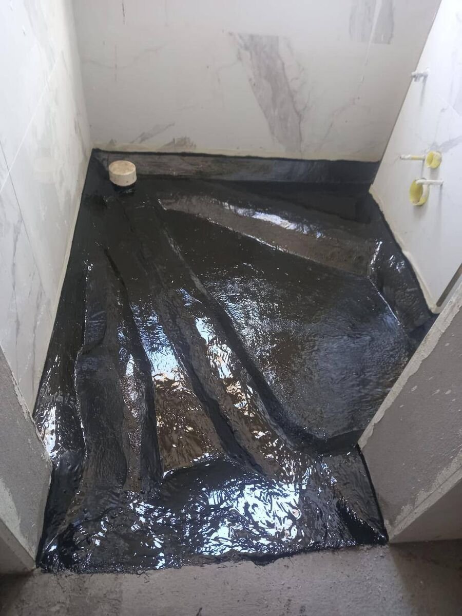 Bitumen membrane to a wet area, dressed up and around the outlet.